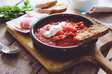 Ukrainian and russian national red soup borsch. Beetroot soup on wooden background