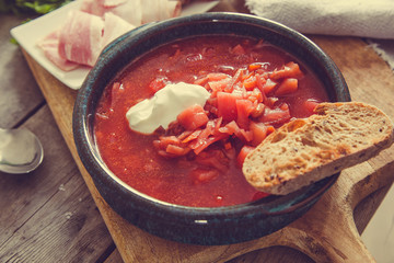 Ukrainian and russian national red soup borsch. Beetroot soup on wooden background