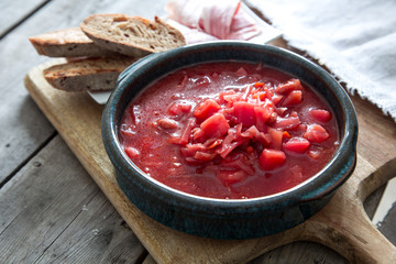 Ukrainian and russian national red soup borsch. Beetroot soup on wooden background