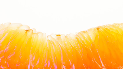 Pomelo fruit macro photography. Peeled pomelo slice on a white background. Carpels with Juicy...