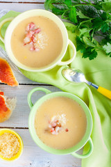 Two plates of mashed potato soup with bacon, top view, selective focus