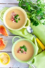 Two plates of mashed potato soup with bacon, top view, selective focus