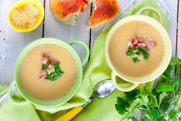 Two plates of mashed potato soup with bacon, top view, selective focus