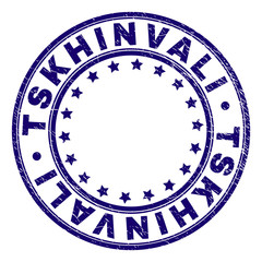 TSKHINVALI stamp seal watermark with distress texture. Designed with circles and stars. Blue vector rubber print of TSKHINVALI tag with grunge texture.