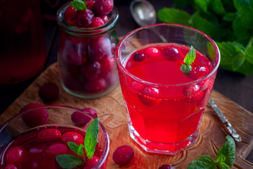 Cranberry juice from frozen cranberries on a wooden board, horizontal