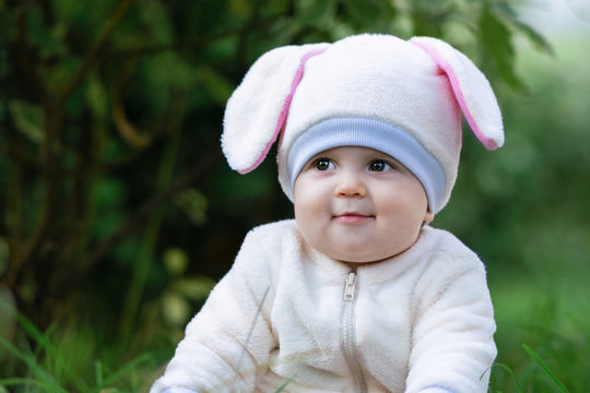 Baby girl with chubby cheeks in bunny costume.