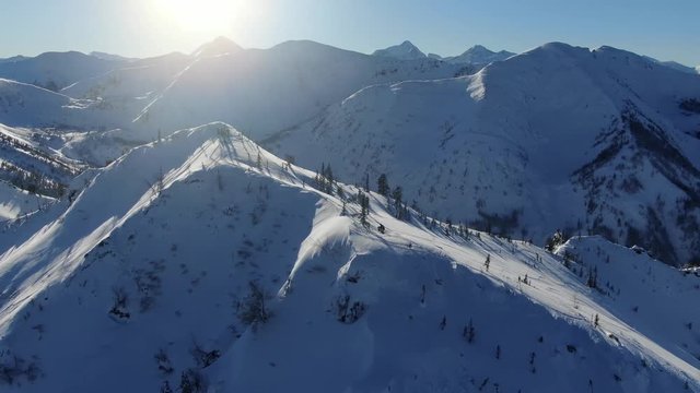 Aerial drone shot ski trail of snowy mountain slope