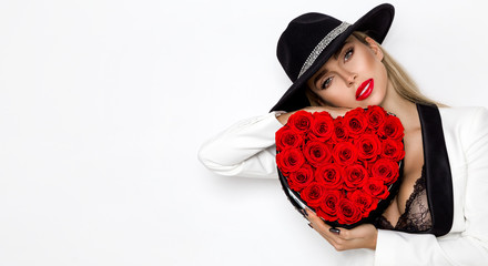 Valentine Beauty, elegant girl with red heart with roses. Portrait of a young female model with gift and hat, isolated on background. Beautiful Happy Young woman presenting flower box.