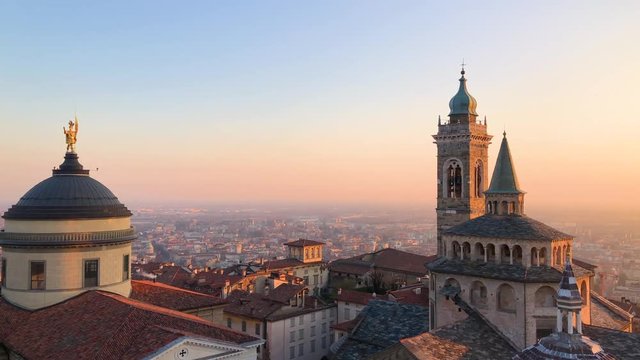 Panoramic view of the Basilica of Santa Maria Maggiore, Cappella Colleoni Chapel and the Cathedral in Citta Alta of Bergamo, Northern Italy during sunset, 4k footage video.