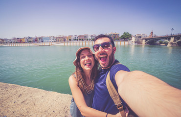 Fototapeta na wymiar happy smiling tourist take photo selfie in the street of Sevilla, Spain