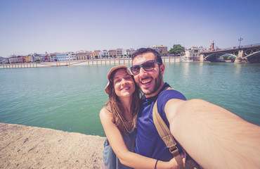 Fototapeta na wymiar happy smiling tourist take photo selfie in the street of Sevilla, Spain