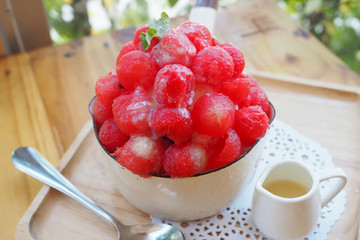 Fresh red watermelon bingsu on wooden table