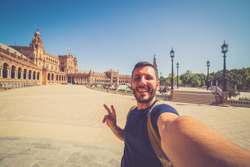 happy smiling man take photo selfie in Spain square (plaza de espana) in Sevilla, Spain