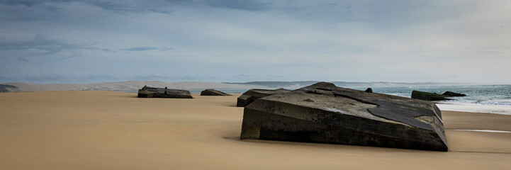 world war ii relics and concrete bunkers on the beach at plage cap ferret in france near bordeaux during a cold winter's day
