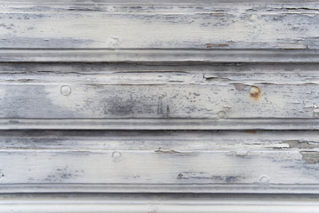Old weathered white oak wood surface with long boards lined up. Wooden planks on a wall or floor with grain and texture. Light neutral tones. Old wooden wallpaper and background concept.