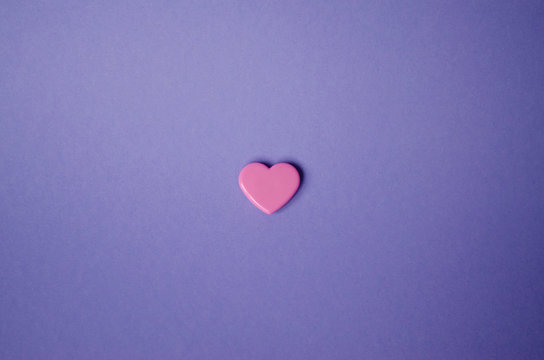 Light pink heart on a purple background