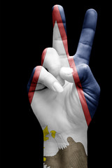 and making victory sign, American samoa painted with flag as symbol of victory, win, success -...