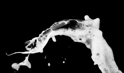 White bubble foam splash explosion in the air on black background,freeze stop motion photo object...