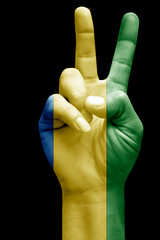 and making victory sign, Gabon painted with flag as symbol of victory, win, success - isolated on...