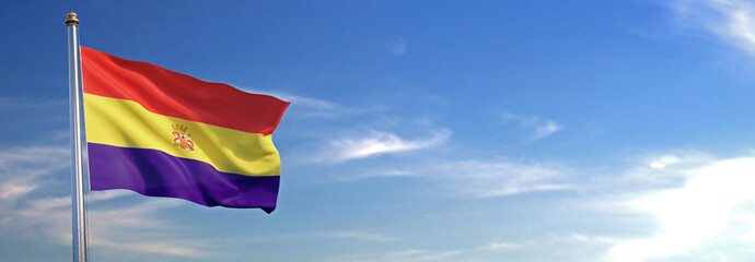 Bandera de la segunda Republica Española subida ondeando al viento con cielo de fondo
