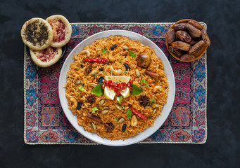 Homemade chicken Biryani. Arabic traditional food bowls Kabsa. Top view. 
