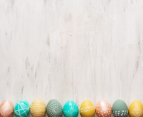 decorated easter eggs on white wooden background