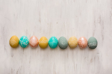 decorated easter eggs on white wooden background