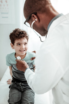 Attentive kid communicating with his family doctor