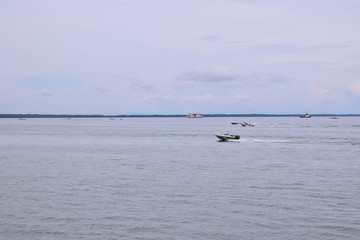 speedboat and fishing boat on the lake