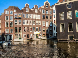 Fototapeta na wymiar Houses in the water canal in Amsterdam