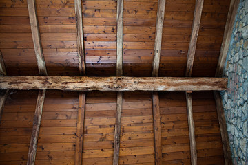 Wooden hand made roof in old, stone built country house in Italy.