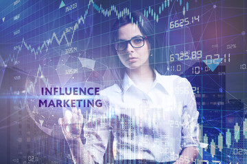 The concept of business, technology, the Internet and the network. A young entrepreneur working on a virtual screen of the future and sees the inscription: Influence marketing