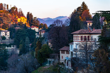 Beautiful fairytale houses in a valley of Bergamo near Citta Alta during sunrise, Italy.
