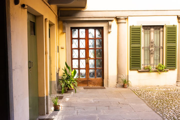Wooden front door outside old Italian house in Bergamo, Italy.