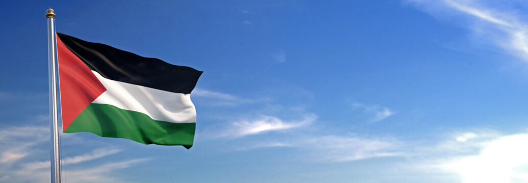 Flag of Palestine rise waving to the wind with sky in the background