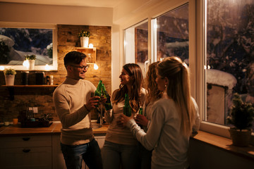 Millenials at casual home party on winter night.
