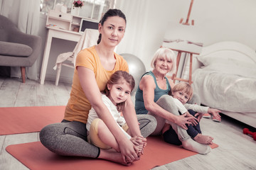 Women doing yoga training for children at home