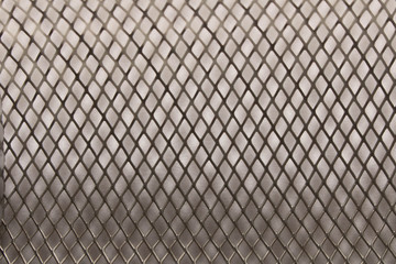 Fototapeta premium Metal mesh background texture. On white background. Close up. Selective focus.