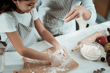 Small kid cooking a tasty dinner with mother
