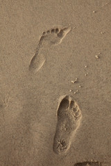 Human trace of a foot on yellow sand