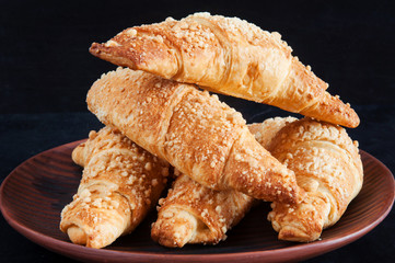 Croissants on black background.