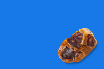 Whole brown dried date fruit on blue background with copy space for your text