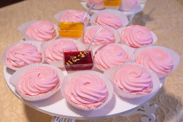 A plate of different sweets, pink marshmallow and sweet fruit jelly