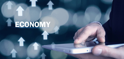 Man holding growth arrows with Economy word.