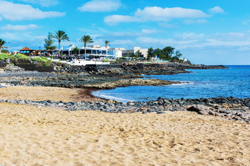 View of Playa Bastian beach in Costa Teguise, Lanzarote, Spain, clear turquoise waters, selective focus