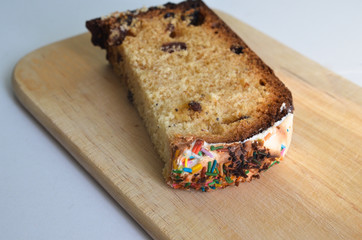 There is a burnt piece of cake on the wood