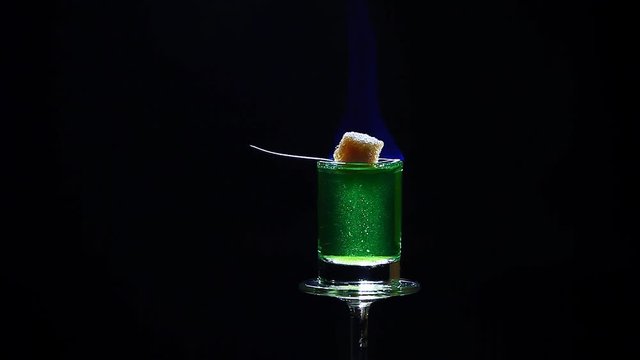 absinthe shot glass cane sugar spoon fire dark background hd footage 