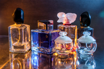 Collection of perfume bottles on dark background