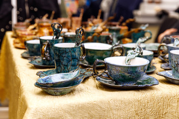 Handmade ceramics on the market. Mugs, plates