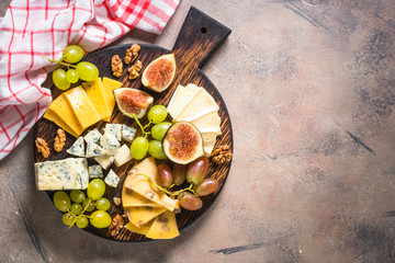Cheese plate with grapes, figs and nuts. 